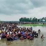 Bangladeshi Hindus standing in water and pleading with BSF