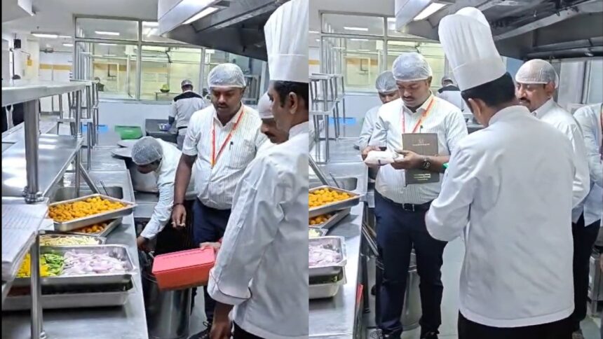 Team of chefs in white uniforms and hairnets inspect trays of food on a stainless steel prep line in a commercial kitchen